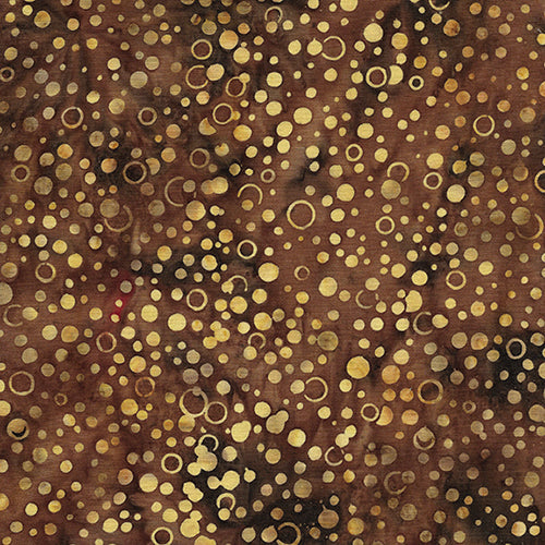This batik cotton fabric features tan dots on brown tones. Available at Colorado Creations Quilting