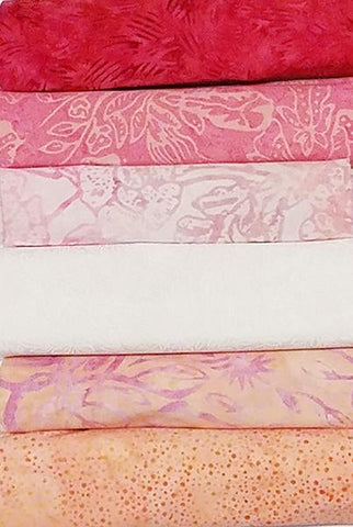 A 6-Pack is six coordinated half-yard pieces of fabric. This particular kit is called Bubblegum. It includes pinks, oranges, white and a "zinger" of dark pink fabric.