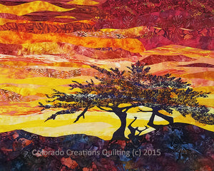This quilt features a silhouette of a cypress tree in front of a brilliant orange/red/yellow sunset sky.  All the fabric needed to complete the quilt top and the pattern.  Lone Cypress quilt kit available at Colorado Creations Quilting.