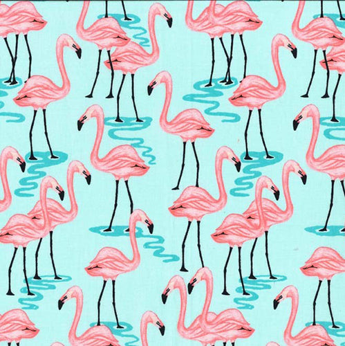 This cotton fabric features stylized pink flamingoes on an aqua blue background.