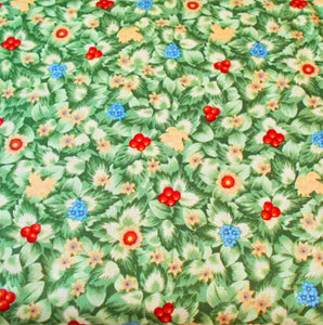 This cotton fabric features small packed green leaves sprinkled with little flowers. 