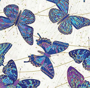 This cotton batik fabric features vibrant blue and purple butterflies in flight on a white background. Available at Colorado Creations Quilting
