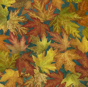 This cotton quilting fabric features large fall-colored maple leaves on a teal blue background