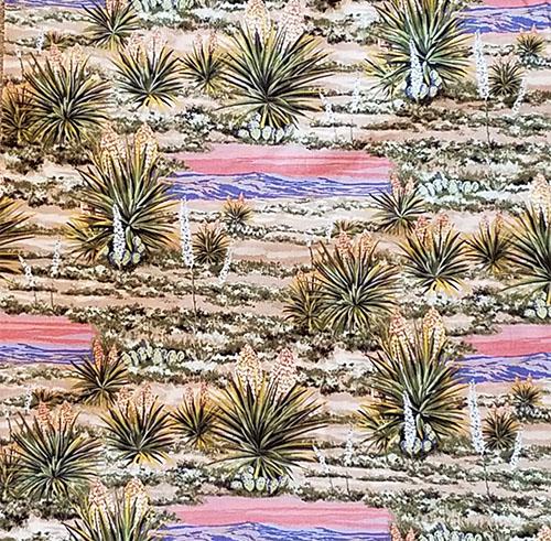 Blooming yucca on the desert floor with a backdrop of purple mountains and a sunset sky cotton fabric. Available at Colorado Creations Quilting