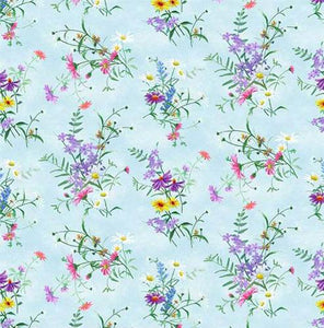 Dainty wildflowers of purple and yellow on a light blue background. Available at Colorado Creations Quilting
