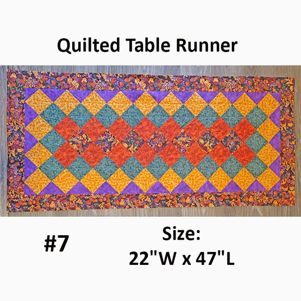This quilted runner has small squares in fall colors done in a Seminole-staggared fashion. Designed by Jackie Vujcich.