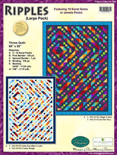 This quilt kit features large squares, vibrant pure colors of the rainbow. The pattern features brightly-colored triangles and squares on a black background in alternating rows to form a diamond. 