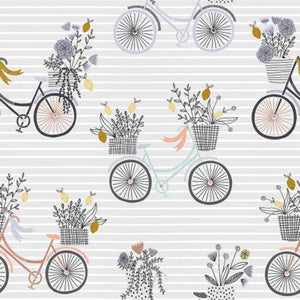 This cotton fabric features darling bikes in shades of mint green, gray and peach all carrying a basket of flowers on a gray background.