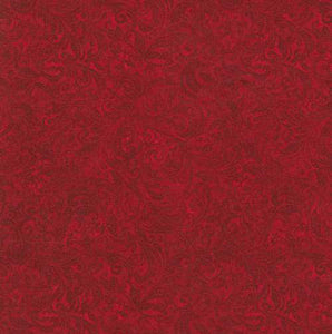 This tonal (reads as a solid) fabric features deep red colored filigree scroll designs