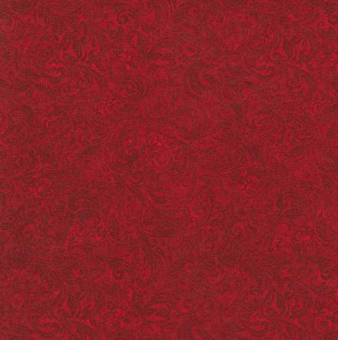 This tonal (reads as a solid) fabric features deep red colored filigree scroll designs