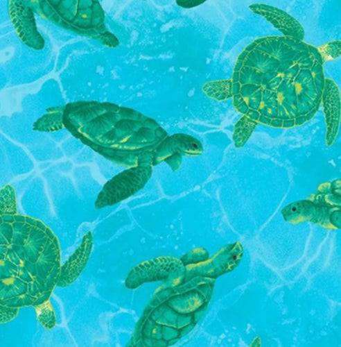 This cotton fabric features brightly-colored seahorses on a blue background. Available at Colorado Creations Quilting.