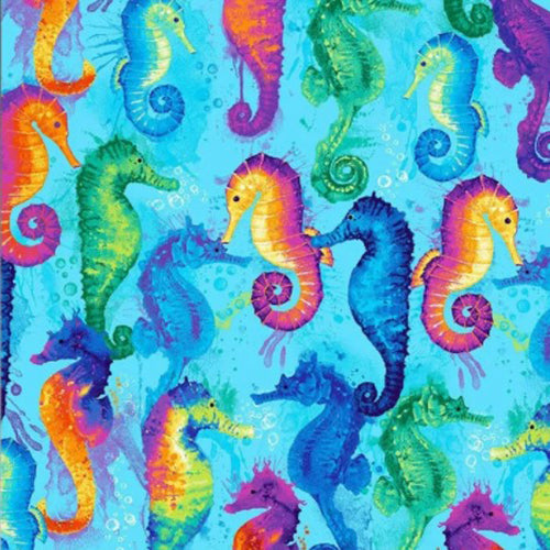 This cotton fabric features brightly-colored seahorses on a blue background. Available at Colorado Creations Quilting.