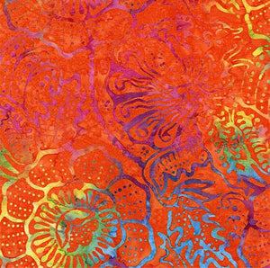 This orange batik cotton fabric features large tropical flowers