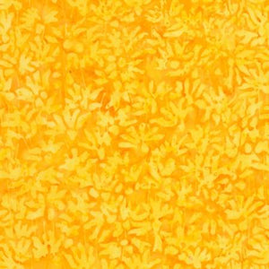 A mango yellow tonal fabric featuring flowering buds. Available at Colorado Creations Quilting