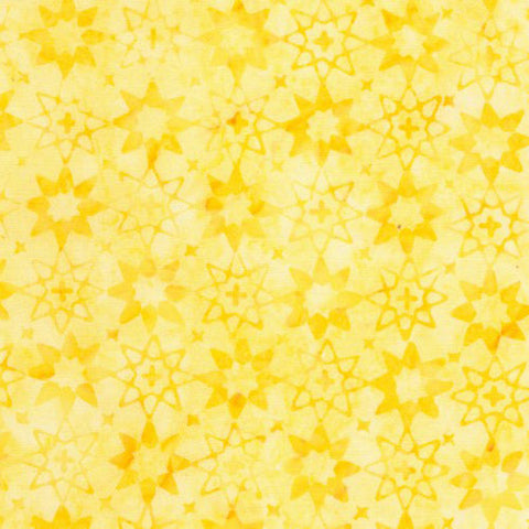 This batik cotton fabric features tonal (reads as a solid) light yellow stars.