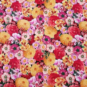 Multiple packed flowers in pinks, yellows, orange and red are featured in this Timeless Treasures fabric.