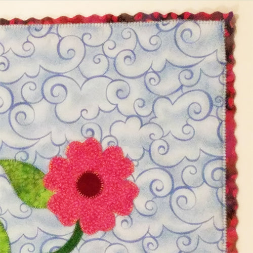 Close up view of scalloped edging on a small art quilt