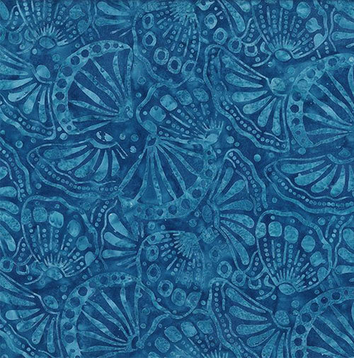 This batik tonal fabric features seashells on a dark rich blue background Cotton Fabric