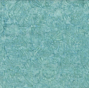 This batik tonal fabric features sand dollar-like seashells on a turquoise background Cotton Fabric